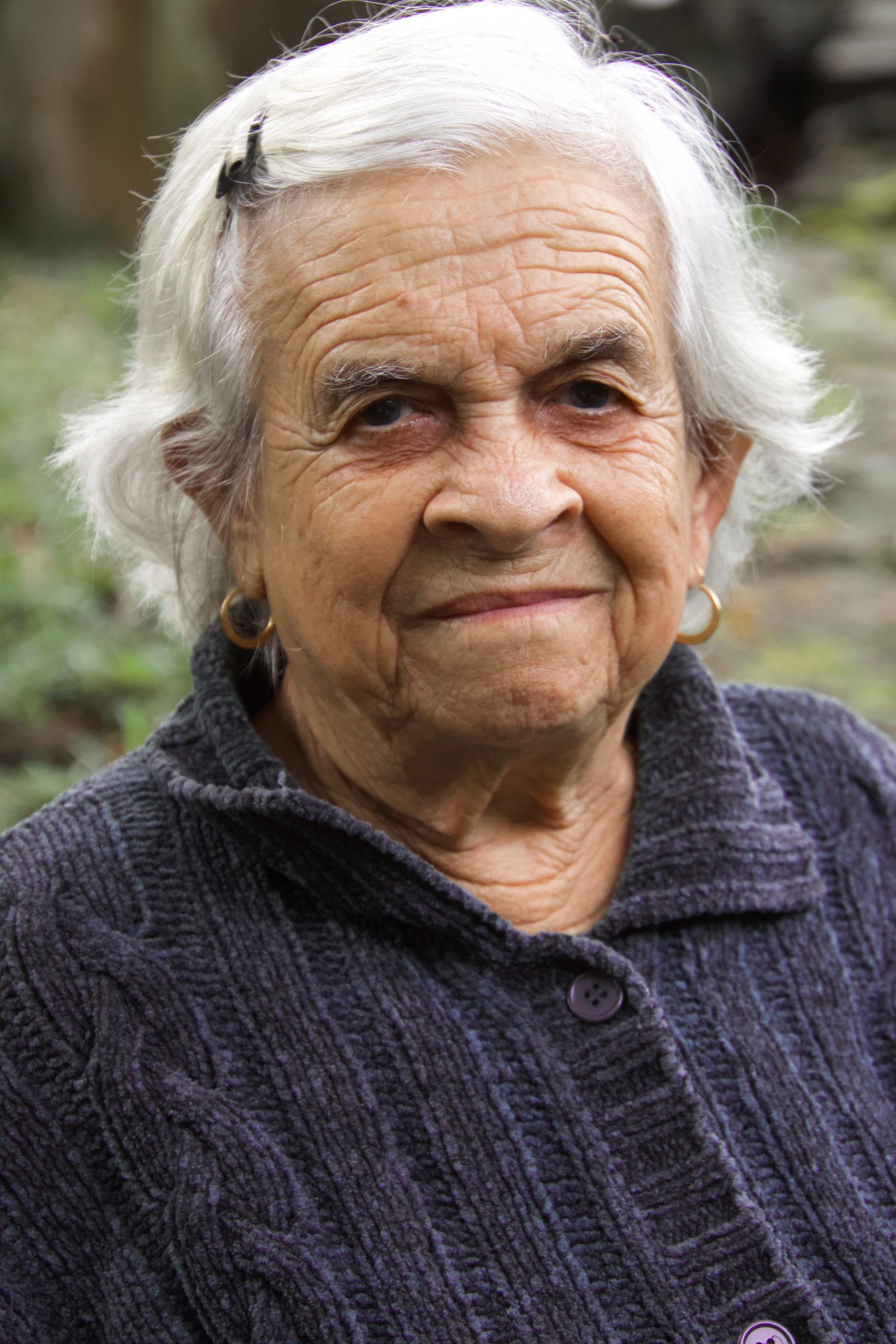 Portrait of a happy senior woman with white hair outdoors in Saint-Pierre, Réunion.