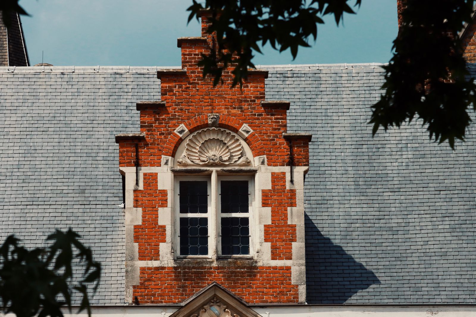 Close-up of traditional brick and slate rooftop in Bruges, showcasing historic architecture.