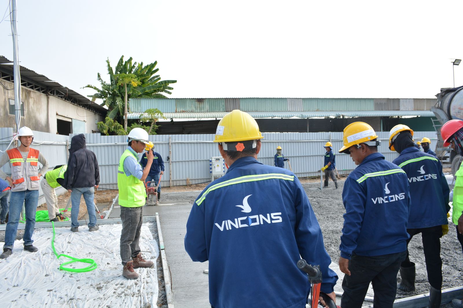 Construction team in hard hats reviewing a job site